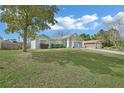 Beautiful home showcases a vast front lawn leading to a charming facade and an attached two-car garage at 2937 Garret St, Deltona, FL 32738