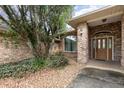 Beautiful brick home exterior showcasing the front entrance with stone landscaping and a small lawn area at 3 Whipper In Cir, Ormond Beach, FL 32174