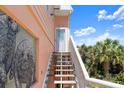 Exterior stairs leading to a beach home entrance with a tile wall at 3000 Ocean Shore Blvd # 6, Ormond Beach, FL 32176