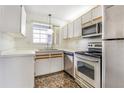 Efficient kitchen with stainless steel appliances, ample cabinets, and a window over the sink at 313 Dirksen Dr # G4, Debary, FL 32713