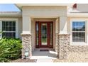 Inviting front entrance with decorative glass door and stone columns at 319 E Victoria Trails Blvd, Deland, FL 32724
