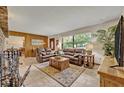 Open living room with tile floors, leather sofas, and views of the front yard at 349 Evansdale Rd, Lake Mary, FL 32746
