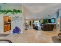Spacious living room featuring tile floors, comfortable leather furniture, and large windows for natural light at 4029 N Waterbridge Cir, Port Orange, FL 32129