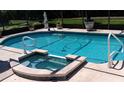 Inviting pool with hot tub and tranquil water feature offers a relaxing outdoor oasis at 4029 N Waterbridge Cir, Port Orange, FL 32129