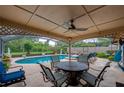 Covered outdoor patio with a pool, a ceiling fan, and comfortable seating for relaxing and entertaining at 4029 N Waterbridge Cir, Port Orange, FL 32129