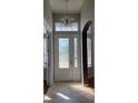 Inviting foyer with a decorative glass front door and tile flooring at 421 Holly Fern Trl, Deland, FL 32720