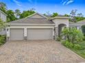 Lovely single-story home boasting a three-car garage, stone accents, and lush landscaping at 425 Wedgeworth Ln, Deland, FL 32724