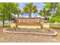 Elegant community entrance sign for Oak Hill Plantation, surrounded by lush landscaping at 4273 Ne 29Th Pl, Ocala, FL 34470