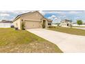 Inviting home featuring a two-car garage, situated on a large lot with a well-kept lawn at 4273 Ne 29Th Pl, Ocala, FL 34470