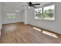 Bright bedroom featuring stylish wood-look flooring, ceiling fan, and fresh, white walls at 430 S Woodward Ave, Deland, FL 32720