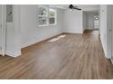 Bright living room featuring stylish wood-look flooring and fresh, white walls at 430 S Woodward Ave, Deland, FL 32720