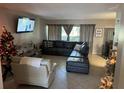Cozy living room with large sectional sofa, TV, and natural light creates a comfortable atmosphere at 4555 Tower Pine Rd # Ge, Orlando, FL 32839