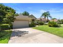 Inviting single-story residence with a spacious driveway, green lawn, and mature landscaping at 508 Quail Lake Dr, Debary, FL 32713