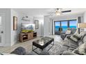 Inviting living room with ocean view through sliding glass doors to balcony at 5207 S Atlantic Ave # 723, New Smyrna Beach, FL 32169