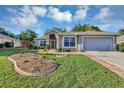 Inviting single-Gathering home with a landscaped front yard and two-car garage at 5305 Indian Ocean Loop, Tavares, FL 32778