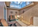 Covered patio with stylish furniture and decorative sunburst wall art at 5305 Indian Ocean Loop, Tavares, FL 32778