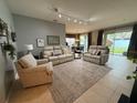 Inviting living room featuring neutral paint, tile flooring, and comfortable seating arrangement at 5548 Burlwood Dr, Orlando, FL 32810