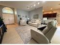 Open-concept living area with bright neutral paint, tile floors, and view of kitchen at 5548 Burlwood Dr, Orlando, FL 32810