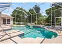 Sparkling pool with a screened enclosure and integrated spa, perfect for relaxation and entertaining at 6111 Oxbow Bend Ln, Port Orange, FL 32128