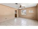 Bright living room with tile flooring, a ceiling fan, and views of the outside at 630 Florida Ave, Daytona Beach, FL 32117