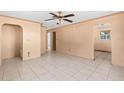 Neutral living room featuring tile flooring, several archways, and views of the adjoining spaces at 630 Florida Ave, Daytona Beach, FL 32117