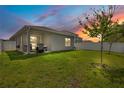 Backyard with green grass and a privacy fence at sunset at 7068 Lanier Falls Rd, Deland, FL 32724