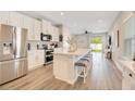 Bright kitchen featuring stainless appliances, a center island, and bar stool seating at 7068 Lanier Falls Rd, Deland, FL 32724