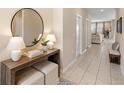 Inviting foyer with modern console table, round mirror, and neutral color palette at 716 Riviera Bella Dr, Debary, FL 32713
