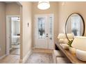 Bright foyer featuring a decorative front door, console table, and a view into the bedroom at 716 Riviera Bella Dr, Debary, FL 32713