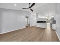 Spacious living room featuring light wood floors, neutral paint, and open view into kitchen area at 717 S Ridgewood Ave, Ormond Beach, FL 32174