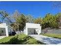 Stylish home featuring a covered parking, modern design, and a well-maintained lawn at 736 S Stone St, Deland, FL 32720