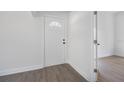 Bright hallway with laminate flooring and a white door at 742 S Martin Luther King Blvd, Daytona Beach, FL 32114