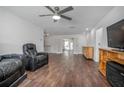 Spacious living room features a ceiling fan, hardwood floors and entertainment center at 792 Bennett Rd, South Daytona, FL 32119