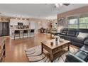 Open concept living space with modern kitchen island, dining area, and comfortable living room furniture at 859 Oak Hollow Loop, Deland, FL 32724