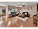 Spacious living room featuring hardwood floors, leather sofas, and an area rug that adds warmth to the space at 859 Oak Hollow Loop, Deland, FL 32724