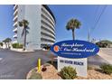 Exterior building sign for Riverplace One Hundred at 100 Silver Beach with palm trees at 100 Silver Beach Ave # 716, Daytona Beach, FL 32118