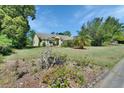 Landscaped front yard with flowers and greenery highlighting this delightful home at 1033 Pearl Tree Rd, Deltona, FL 32725