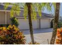 Spacious three-car garage with a paved driveway and well-maintained landscaping at 1117 Oxbridge Ln, Ormond Beach, FL 32174