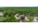 An aerial view of the home's location surrounded by mature trees in a tranquil neighborhood setting at 115 San Marino Ln, Deland, FL 32724