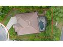 Aerial view showcasing a private backyard pool and patio area, surrounded by lush landscaping at 115 San Marino Ln, Deland, FL 32724
