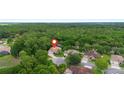 Aerial photograph pinpointing a property's location amidst lush trees within a quiet neighborhood at 115 San Marino Ln, Deland, FL 32724