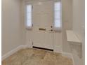 Bright entryway featuring a white door with elegant molding and tile flooring at 117 N Garfield Ave # 16, Deland, FL 32724