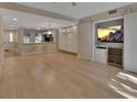 Spacious living room with light wood floors and sliding barn door to the entertainment center at 117 N Garfield Ave # 16, Deland, FL 32724