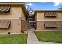Inviting condo exterior featuring a walkway and charming window awnings for added curb appeal at 140 Orchid Woods Ct # 14B, Deltona, FL 32725