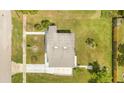 Aerial view of a compact home highlighting its roof, yard, and surrounding greenery at 1479 Renton St, Deltona, FL 32725