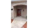 Close-up of the elegant front door with glass detailing and brick surround at 1491 E Palomar Dr, Deltona, FL 32738