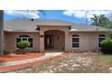Beautiful brick home featuring a welcoming front entrance with a brick archway at 1491 E Palomar Dr, Deltona, FL 32738