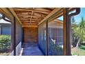 The screened-in porch has a wood plank floor and a view of the outdoors at 160 Rose Ave, Lake Helen, FL 32744