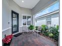 Charming front patio featuring brick pavers, a cozy seating area, and a well-manicured garden at 173 Old Moss Cir, Deland, FL 32724