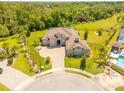 Expansive estate featuring a meticulously landscaped yard, circular driveway, and pristine surroundings at 1855 Cattle Creek Ln, Port Orange, FL 32128